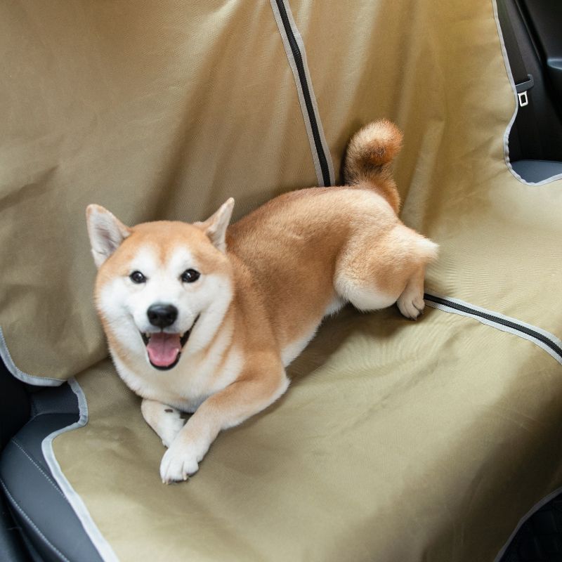 Happy dog relaxing on UrbanTrail Multifunctional Dog Car Seat Protector in car