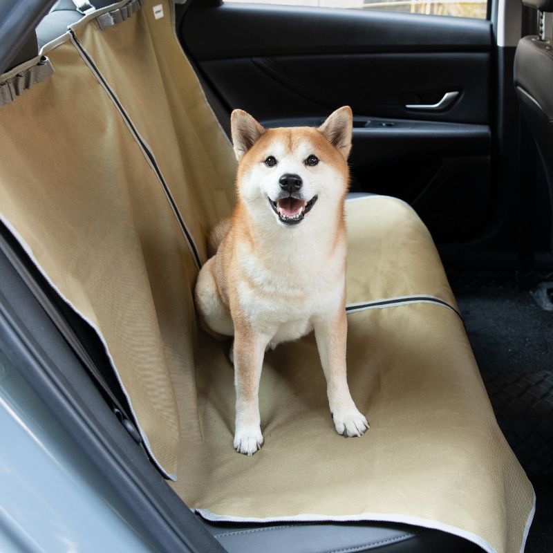 Shiba Inu sitting on urbanTrail multifuncational dog car seat protector in vehicle, protecting car seats