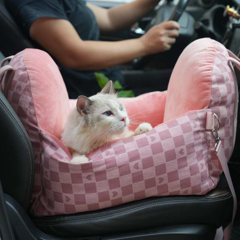 Pink tartan pet car seat with cat, secure and cozy for vehicle travel