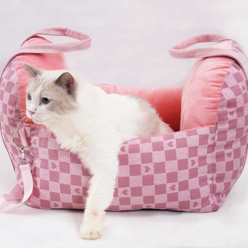 Pink tartan pet car seat with cat, soft interior and carrying handles for secure pet travel