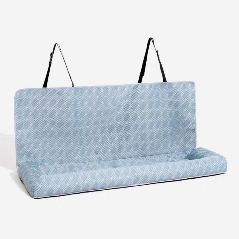 Blue patterned seat cover with black straps on a white background