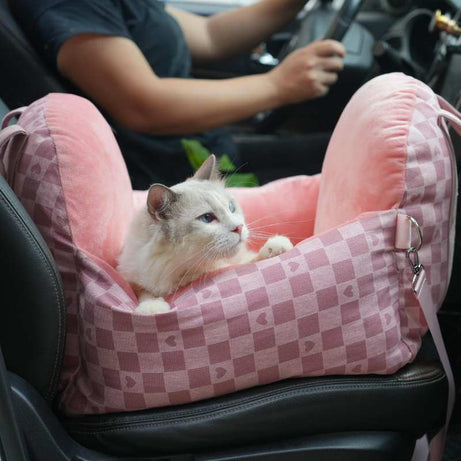 Pink tartan pet car seat with cat, secure and cozy for vehicle travel